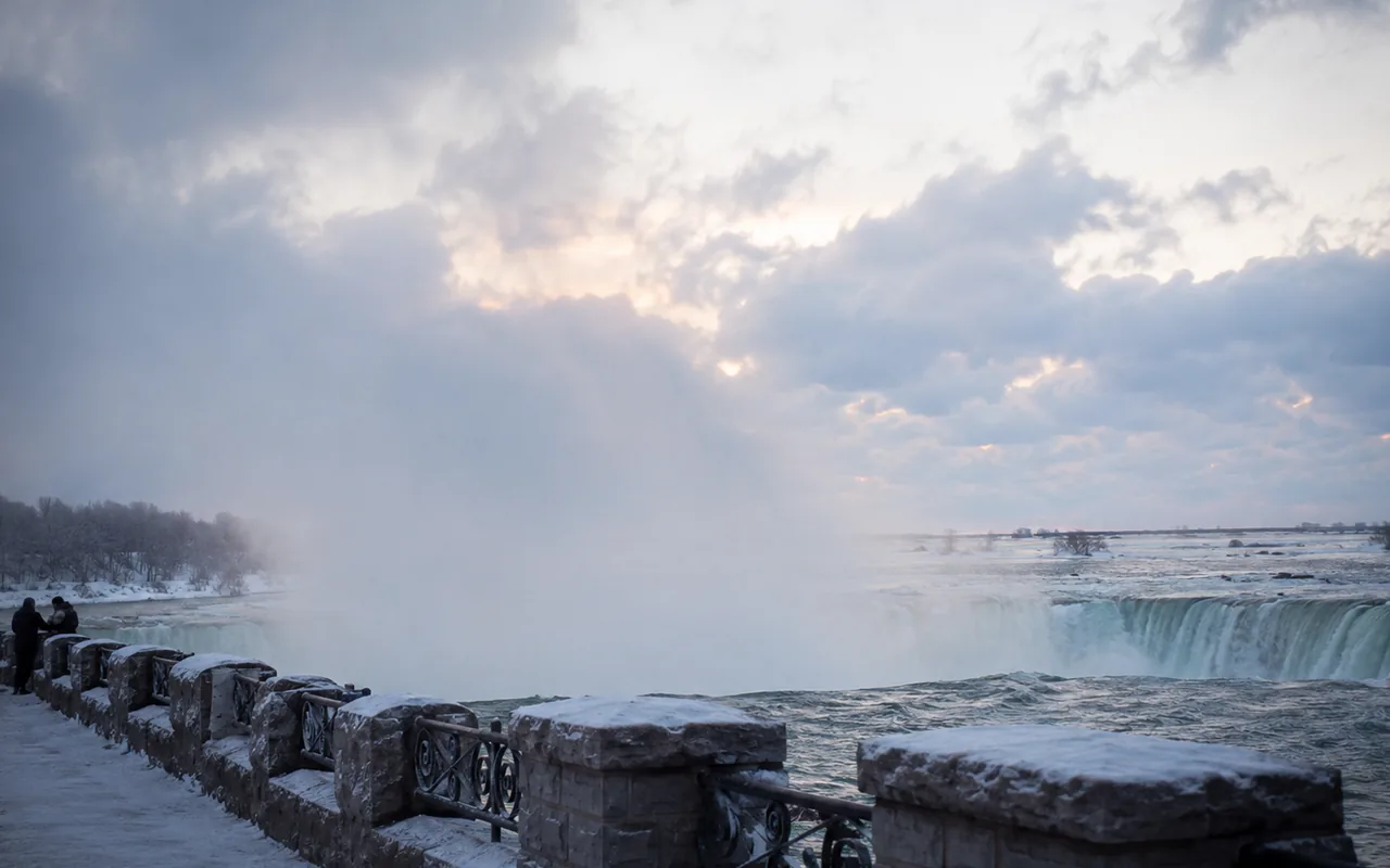 Wide view of a Great Lakes waterfall overlook in cool winter light, no identifiable trademarks or signage